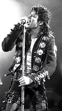 A photograph of Michael Jackson singing into a microphone