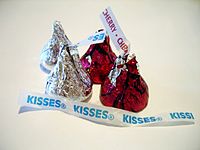 Original milk chocolate Hershey's Kisses beside Cherry Cordial Creme Filled Kisses