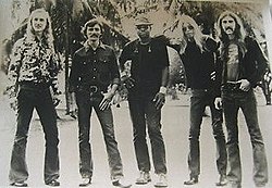 The musicians standing in a line, facing the camera