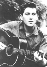 Phil Ochs in the early 1960s playing his Gibson J-45.